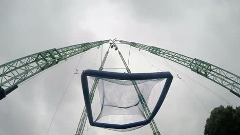 Man-jumps-into-a-giant-hanging-trampoline-at-the-amusement-park