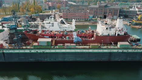 Drone-flying-near-the-cargo-ship-in-shipyard-docks