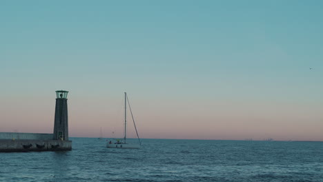Yacht-sailing-into-the-bay-on-the-baltic-sea-at-the-sunset-in-Gdynia