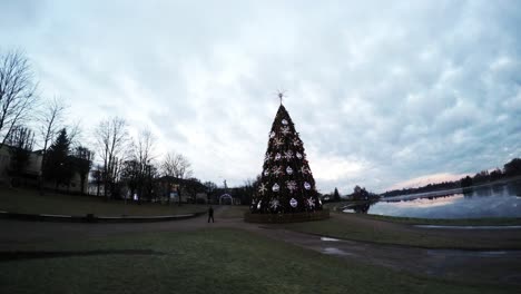 Close-Up-Of-Dramatic-Clouds-Over-The-Charming-Christmas-Tree-Near-The-River-1