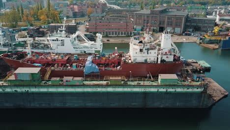 Drone-flying-near-the-cargo-ship-in-shipyard-docks-1