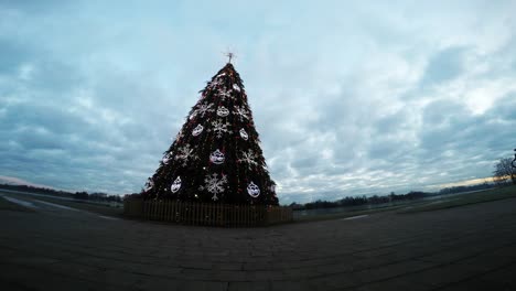 Close-Up-Of-Dramatic-Clouds-Over-The-Charming-Christmas-Tree-Near-The-River