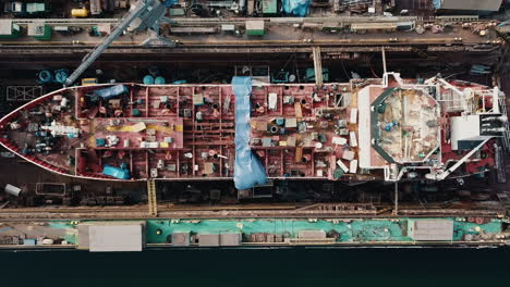 Drone-flying-above-the-cargo-ship-in-the-shipyard-docks