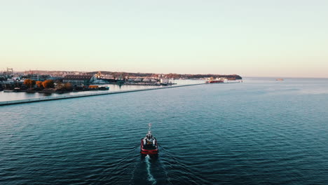 Drone-flying-over-the-fishing-boat-sailing-on-the-sea-at-the-sunset-2