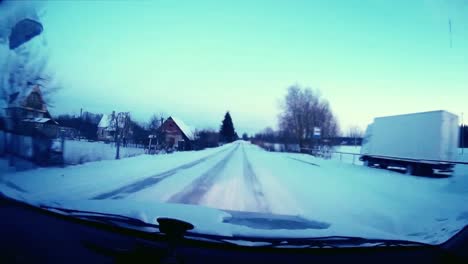 Driving-a-car-with-a-frozen-windshield-over-the-village