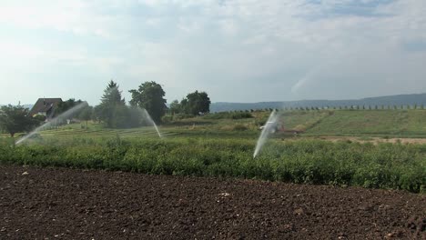 Sprinkler-irrigation-on-a-field-in-Bavaria,-Germany