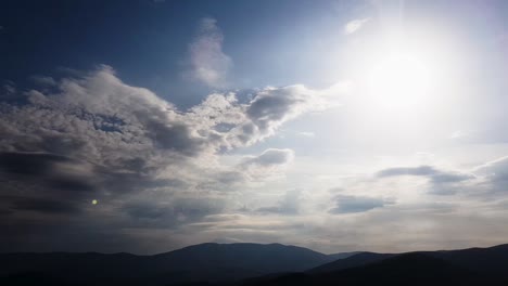 Time-lapse---blue-sky-and-clouds,-mountain-in-background