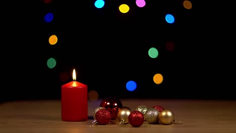 Candle-next-to-christmas-ornament-with-bokeh-background