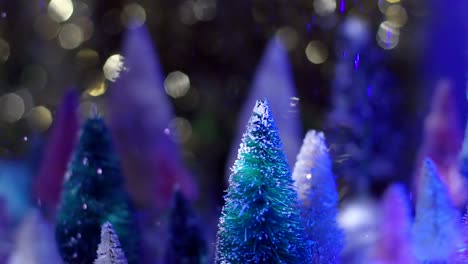 Slow-Motion-nighttime-shot-of-glitter-snow-falling-on-top-of-vintage-bottle-brush-tree