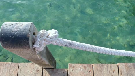 A-rope-from-a-footbridge-over-the-turquoise-water-of-mediterranean-sea