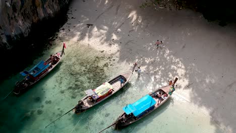 Drone-footage-of-boats-on-the-shore-of-a-deserted-island