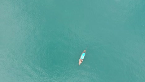 Drone-footage-of-longtail-boat-navigating-in-the-middle-of-the-ocean-with-nothing-around