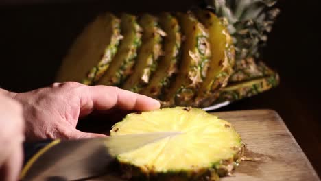 Male-Slicing-Comosus-Pineapple-Ananas-With-a-Knife