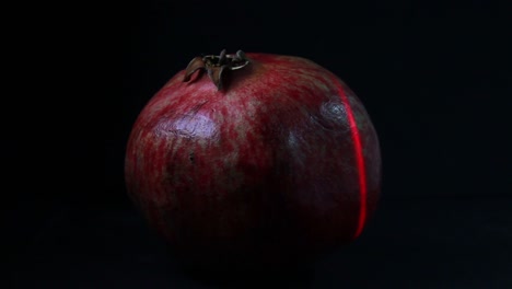 Rotes-Laserlicht-Tastet-Die-Granatapfelfrucht-Im-Dunkeln-Ab