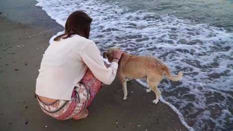 Girl-playing-with-dog-one-the-beach