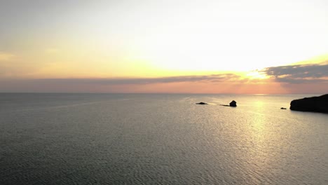 Aerial-panning-footage-of-sunrise-over-sea-and-seashore-,-Bulgaria