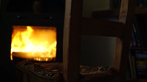 Chair-in-front-of-the-burning-fireplace