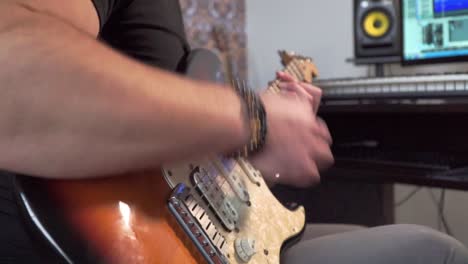 Playing-guitar-at-home-studio