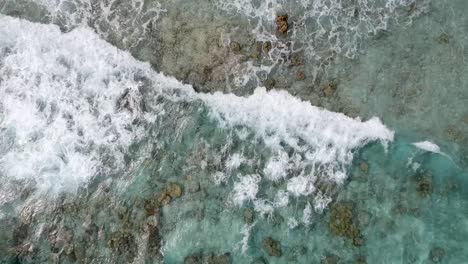 Drone-footage-of-crystal-clear-blue-water-and-waves-on-the-shore-of-beach-in-Thailand