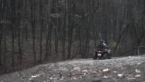 Man-with-girlfriend-ride-a-quad-on-the-misty-forest-road