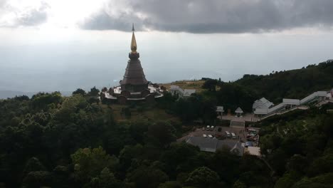 Footage-of-drone-flying-over-the-Temple-Doi-Inthanon-in-Chiang-Mai-in-Thailand-with-the-ocean-bellow-in-the-backgroung-1