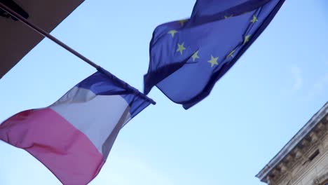 Waving-flag-of-France-and-European-union-with-blue-sky-on-the-background
