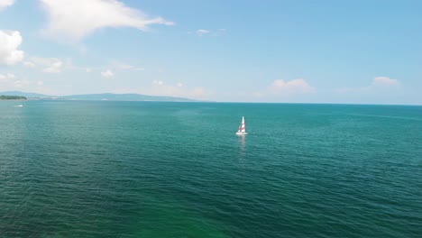 Aerial-shot-of-sailboat-far-away-in-the-sea---Lozenets,-Bulgaria-1