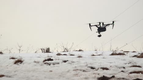 Big-Professional-Drone-DJI-Inspire-2-With-Video-Camera-Flies-Low-Over-The-Snow-While-Blowing-A-Strong-Wind-2