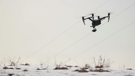 Big-Professional-Drone-DJI-Inspire-2-With-Video-Camera-Flies-Low-Over-The-Snow-While-Blowing-A-Strong-Wind-1