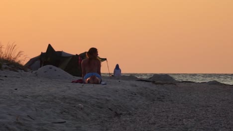 A-woman-doing-yoga-on-the-morning-beach