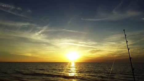 A-fishing-line-glistens-in-the-glden-sunset-in-front-of-the-gulf
