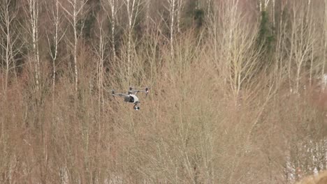 Professional-Drone-DJI-Inspire-2-Flies-Over-The-Forest-While-Blowing-A-Strong-Wind