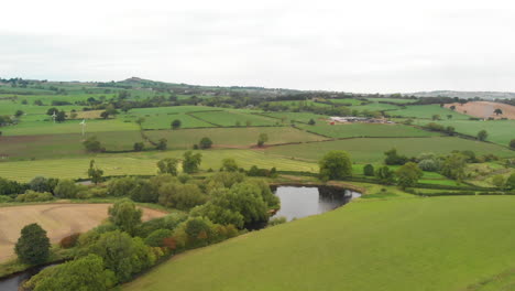 Flight-Above-Fields-and-River-in-Yorkshire-Country-Fields-with-Wind-Turbine