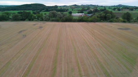 Flight-above-Field-showing-Farm-in-the-Hills