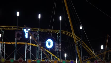 Flashing-neon-sign-Cyclon-on-the-amusement-park-at-night