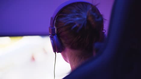 A-shot-of-a-female-pro-gamer-from-back-left-side-playing-an-online-video-game-1