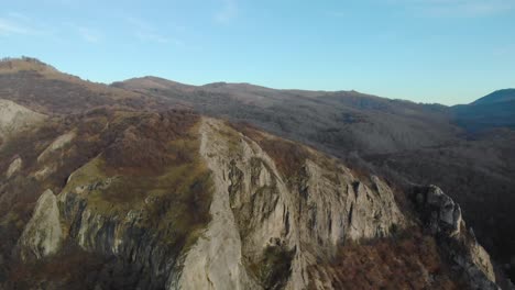 Aerial-shot-of-mountain-hill-with-forest-and-cliffs-5