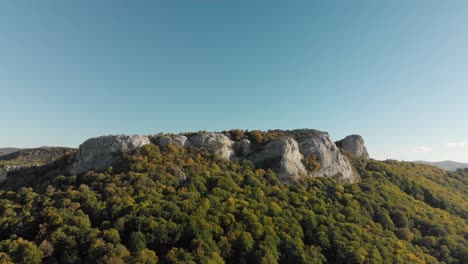 Aerial-panning-shot-around-high-mountain-cliffs