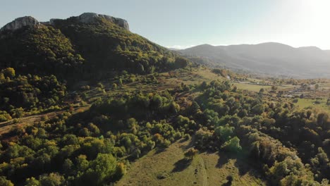Aerial-wide-shot-of-green-valley-at-sunset-2