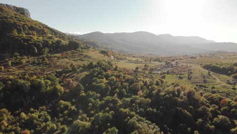 Aerial-wide-shot-of-green-valley-at-sunset
