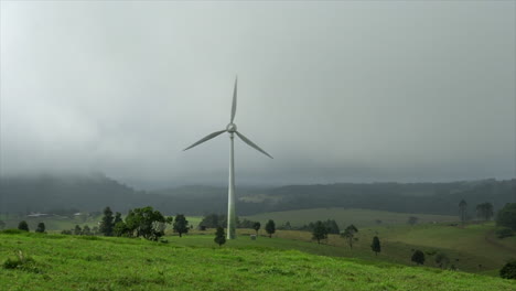 Fast-spinning-wind-turbine-on-rolling-green-hills