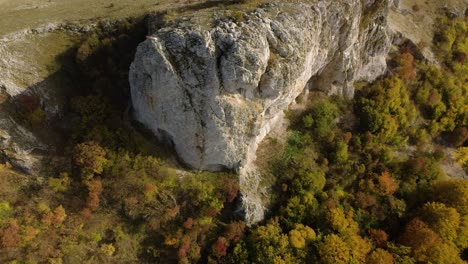 High-angle-aerial-shot-of-rocky-hill-and-landscape-reveal