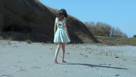 Pretty-girl-in-white-dress-walk-on-the-beach-5