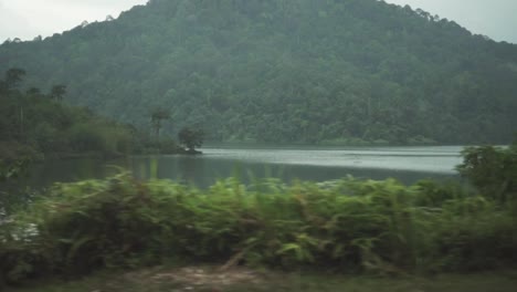 Beautiful-View-Of-Rainforest-Lake-And-Mountain-Slow-Motion-Drive-By-Panning-Shot