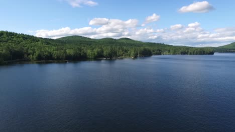 Aerial-Drone-shot-flying-over-Loon-Lake-towards-pregnant-lady-mountain-formation-in-the-Adirondacknew-york,-mountains-in-New-York-on-a-sunny-summer-day