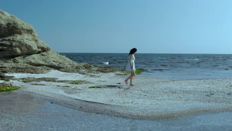 Pretty-girl-in-white-dress-walk-on-the-beach-2