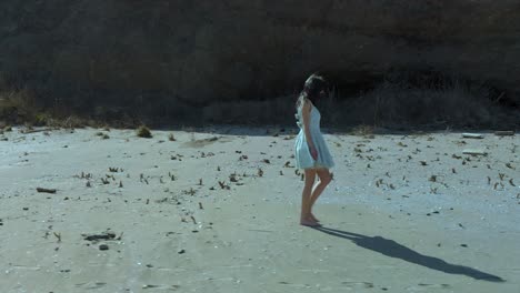 Slow-motion-shot-of-pretty-girl-in-white-dress-walk-on-the-beach-2