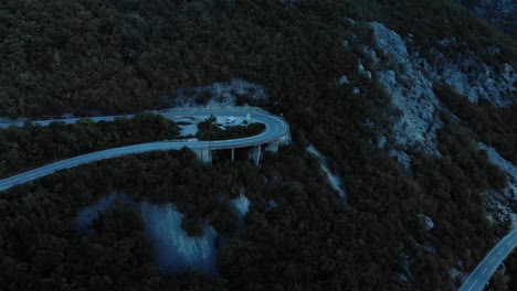 Aerial-medium-shot-of-mountain-road-after-sunset