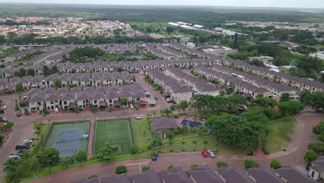 An-passing-by-aerial-view-of-houses-in-a-gated-community-un-Guayaquil,-Ecuador