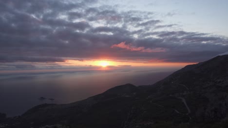 Sunset-through-cloudy-sky-over-Adriatic-sea---panning-shot